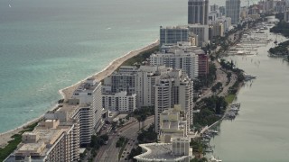 AX0021_025E - 5K aerial stock footage fly over beachfront condominiums on Collins Avenue in Miami Beach, Florida