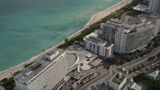 AX0021_027 - 5K stock footage aerial video of condominiums by the beach in Miami Beach, Florida