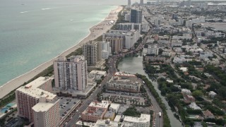 AX0021_034 - 5K aerial stock footage tilt from Indian Creek to reveal condominiums by the beach in Miami Beach, Florida