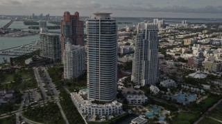 AX0021_059E - 5K aerial stock footage of modern skyscrapers near the beach in South Beach, Florida