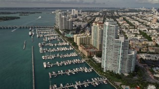AX0021_062 - 5K aerial stock footage of waterfront residential skyscrapers and a marina in South Beach, Florida