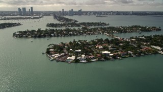AX0021_067 - 5K aerial stock footage approach and flyby waterfront mansions on one of the Venetian Islands, Florida