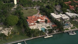 AX0021_069E - 5K aerial stock footage of a row of mansions on the shore of Star Island, Florida