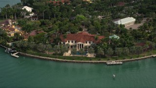 AX0021_072E - 5K aerial stock footage of a bayfront island estate on Star Island, Florida