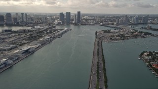 AX0021_076 - 5K aerial stock footage tilt from MacArthur Causeway to reveal Downtown Miami skyscrapers in Florida