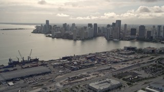 AX0021_077 - 5K aerial stock footage of Downtown Miami skyline seen from the Port of Miami, Florida