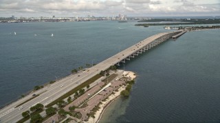 AX0021_109E - 5K aerial stock footage pan across the Rickenbacker Causeway in Miami, Florida