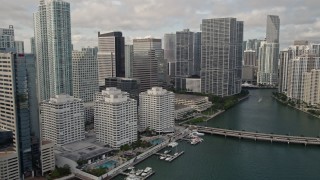 AX0021_120E - 5K aerial stock footage flyby waterfront skyscrapers to reveal Brickell Key Bridge in Downtown Miami, Florida