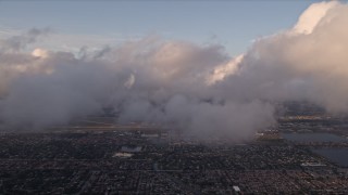 AX0022_019 - 5K aerial stock footage of cloud formations over Kendall suburbs at sunset in Florida
