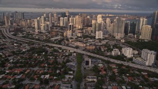 AX0022_026E - 5K aerial stock footage tilt from SW 3rd Avenue to reveal skyscrapers in Downtown Miami at sunset, Florida