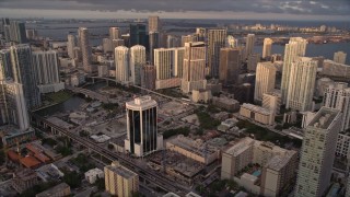 AX0022_028E - 5K aerial stock footage approach skyscrapers in Downtown Miami at sunset, Florida