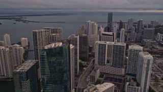 AX0022_035E - 5K aerial stock footage approach skyscrapers on the bay shore in Downtown Miami at sunset, Florida