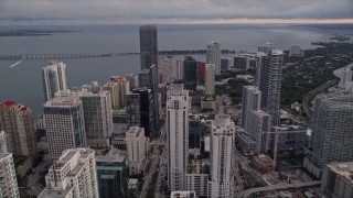 AX0022_039E - 5K aerial stock footage fly over Downtown Miami skyscrapers toward the Rickenbacker Causeway at sunset, Florida