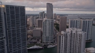 AX0022_046E - 5K aerial stock footage fly between Brickell Key and Icon Brickell in Downtown Miami at sunset, Florida