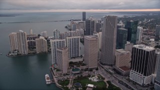 AX0022_050E - 5K aerial stock footage of waterfront skyscrapers around Bayfront Park in Downtown Miami at sunset, Florida