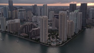AX0022_052E - 5K aerial stock footage of waterfront skyscrapers on Brickell Key in Downtown Miami at sunset, Florida