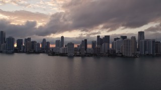 AX0022_054E - 5K aerial stock footage of Downtown Miami skyline at sunset seen from Biscayne Bay, Florida