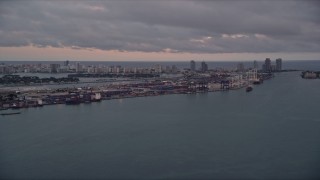 AX0022_060 - 5K aerial stock footage of Port of Miami seen from Biscayne Bay at sunset in Florida