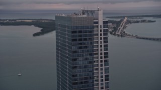 AX0022_069E - 5K aerial stock footage flyby the top of the Four Seasons Hotel tower at sunset in Downtown Miami, Florida