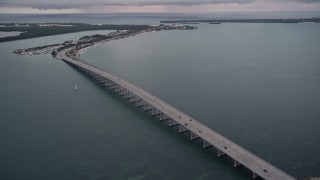 AX0022_071E - 5K aerial stock footage orbit bridge on the Rickenbacker Causeway at sunset, Florida