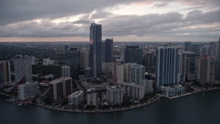 AX0022_079E - 5K aerial stock footage flyby high-rise hotel and waterfront skyscrapers at sunset in Downtown Miami, Florida