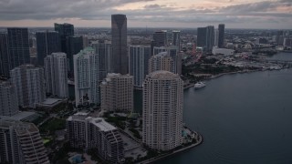 AX0022_081E - 5K aerial stock footage of Brickell Key skyscrapers at sunset, reveal the river in Downtown Miami, Florida