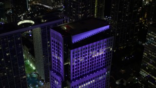 AX0023_010E - 5K aerial stock footage approach the roof of Brickell World Plaza in Downtown Miami at night, Florida