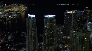 AX0023_023E - 5K aerial stock footage orbit Vizcayne Towers at night in Downtown Miami, Florida