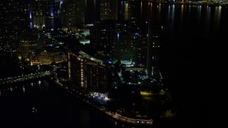 AX0023_036 - 5K aerial stock footage approach Mandarin Oriental Hotel on Brickell Key in Downtown Miami at night, Florida