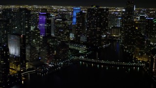 AX0023_054 - 5K aerial stock footage pan across Downtown Miami skyscrapers at night, Florida