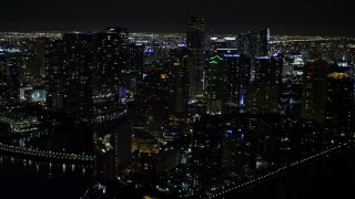 AX0023_055E - 5K aerial stock footage flyby Brickell Key high-rises at night in Downtown Miami, Florida