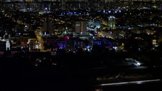 AX0023_073 - 5K aerial stock footage of Ocean Drive hotels with bright lights at night in South Beach, Florida