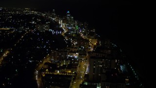 AX0023_081E - 5K aerial stock footage of busy streets through Miami Beach at nighttime, Florida