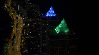 AX0023_087E - 5K aerial stock footage approach Blue and Green Diamonds skyscrapers at night in Miami Beach, Florida