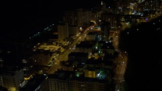 AX0023_102E - 5K aerial stock footage fly over Indian Creek Drive through Miami Beach at night, Florida