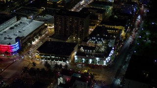 AX0023_113 - 5K aerial stock footage of orbit small hotel and city streets at night in South Beach, Florida