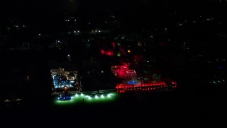 AX0023_129E - 5K aerial stock footage of 5 Star Island Hotel with red lights at nighttime, Florida