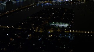 AX0023_134 - 5K aerial stock footage of mansions and tennis courts on Palm Island at night in Florida