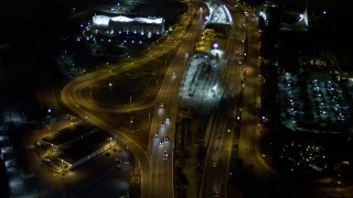 AX0023_136 - 5K aerial stock footage fly over traffic on the MacArthur Causeway through Watson Island at night, Florida