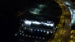 AX0023_137 - 5K aerial stock footage tilt to a bird's eye view of a museum on Watson Island at night, Florida