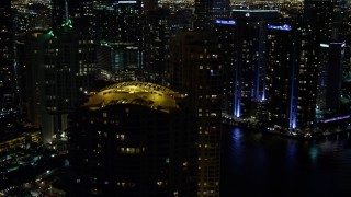 AX0023_150E - 5K aerial stock footage of rooftops of Brickell Key skyscrapers at night in Downtown Miami, Florida
