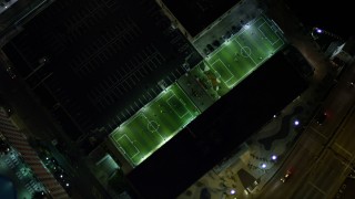 AX0023_169 - 5K aerial stock footage bird's eye view of soccer fields at night in Downtown Miami, Florida