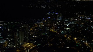 AX0023_186 - 5K aerial stock footage of passing office buildings at night in Coconut Grove, Florida