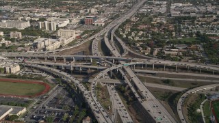 AX0024_036E - 5K stock footage aerial video of Interstate 95 and Highway 836 interchange beside high school, Overtown, Florida