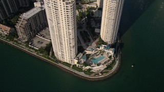 AX0024_043 - 5K aerial stock footage of pool area between condominium complexes on Brickell Key, Downtown Miami, Florida