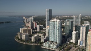 AX0024_044E - 5K aerial stock footage fly over Mandarin Oriental on Brickell Key toward skyscrapers and apartment buildings in Downtown Miami, Florida