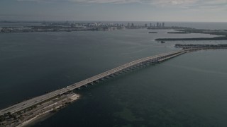 AX0024_049 - 5K aerial stock footage of flying away from the Rickenbacker Causeway on Biscayne Bay, Florida