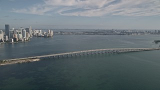 AX0024_050 - 5K aerial stock footage reverse view of Rickenbacker Causeway and reveal Downtown Miami, Florida