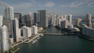 AX0024_054E - 5K aerial stock footage fly low over Biscayne Bay, reveal skyscrapers and Brickell Key, Downtown Miami, Florida