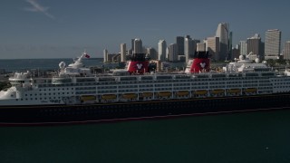 AX0024_066E - 5K aerial stock footage of approaching and flying by Disney Cruise Ship at Port of Miami, Miami, Florida